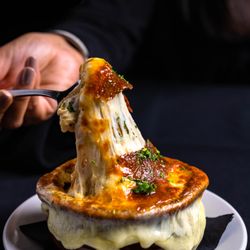 Mo's A Place for Steaks - Rich, slow-simmered French Onion Soup topped with melted cheese and toasted bread--a timeless Mo's steakhouse favorite.