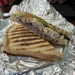 Hillsdale Filling Station - Turkey and roast beef panini on sourdough bread with lettuce tomato pickles mayo and mustard