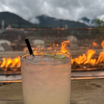 Griz Bar - a drink with a straw in front of a fire pit - Beer Bar Near Me - Juneau, Alaska Griz Bar - a drink with a straw in front of a fire pit - Beer Bar Near Me - Juneau, Alaska