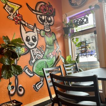 Tres Gringos - a restaurant with a mural of skeletons on the wall - Mexican Near Me - Nederland, Colorado