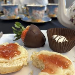 Scones, chocolate covered strawberry, and a petit four Scones, chocolate covered strawberry, and a petit four