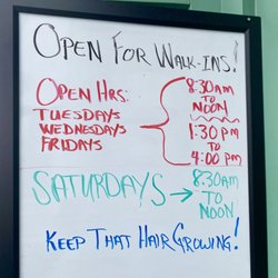 2022-04-28: New hours posted next to barbershop door.