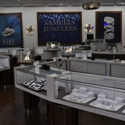 Samuels Jewelers - The 2013 remodel includes wood laminate flooring, hanging chiffon sconces, floating museum boxes and energy efficient lighting.