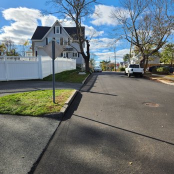 Jvick Lawn Care - a residential street with a white fence - Lawn Services Near Me - Fairhaven, Massachusetts