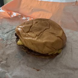 A flattened cheeseburger