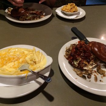 Harrison's - Pulled pork on a pretzel bun with a side of Mac n cheese - American Near Me - Tipp City, Ohio Harrison's - Pulled pork on a pretzel bun with a side of Mac n cheese - American Near Me - Tipp City, Ohio