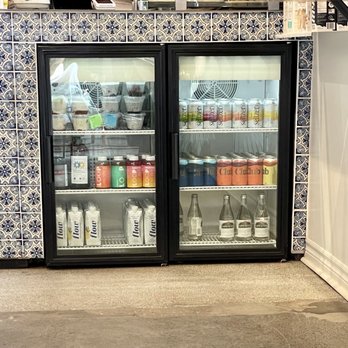 Melk - Cooler with assortment of cold bottled drinks at ordering counter - Coffee & Tea Near Me - Montreal, Quebec Melk - Cooler with assortment of cold bottled drinks at ordering counter - Coffee & Tea Near Me - Montreal, Quebec