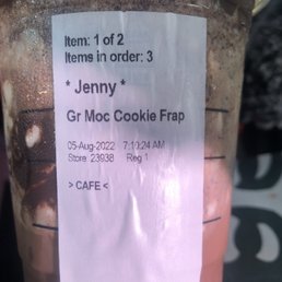 a drink in a plastic cup with a price tag