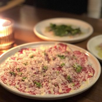 Bacaro - a pizza on a plate on a table - Italian Near Me - Vancouver, British Columbia