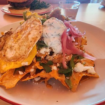 Fanboy - CHILAQUILES: corn chips, tikka dip, bhurta, avocado, queso fresca, cucumber yogurt, pickled onions, fried egg - Cocktail Bars Near Me - Richmond, Virginia