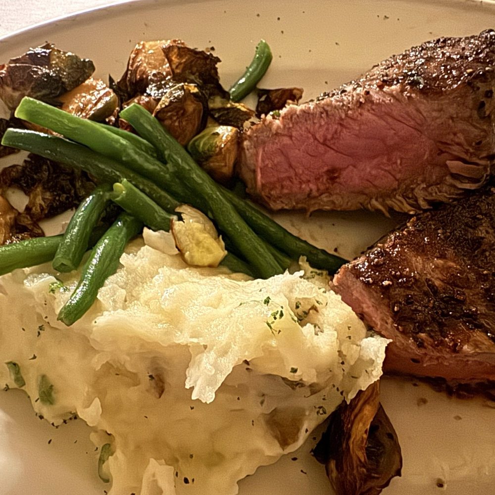 Pappas Bros. Steakhouse - NY Strip with mashed potatoes, crispy brussel sprouts, and haricot verts - Steakhouses Near Me - Houston, Texas Pappas Bros. Steakhouse - NY Strip with mashed potatoes, crispy brussel sprouts, and haricot verts - Steakhouses Near Me - Houston, Texas