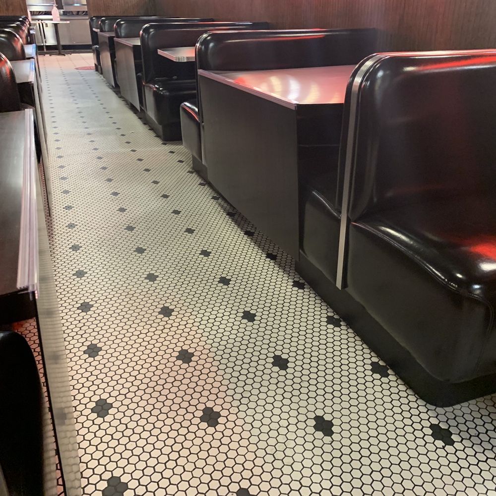 Cute diner floor tiles and discreetly blocked off tables, COVID era.