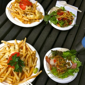 Feastro - four plates of food on a picnic table - Food Stands Near Me - Vancouver, British Columbia
