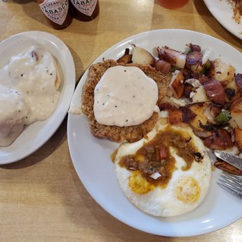 Annia's Kitchen - Chicken fried steak with overcooked eggs and home fries.  Mystery biscuits n gravy had a chunk of tasty roast beef on the bottom. - American Near Me - El Monte, California