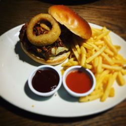 The Burger Joint - Wild boar burger with a brioche bun, bbq pulled pork, beer battered onion rings and melted cheddar cheese.