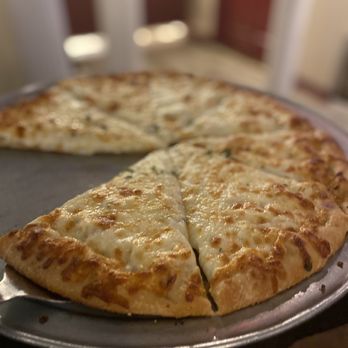 The Grapevine - a cheese pizza on a pan - Italian Near Me - Richmond, Virginia