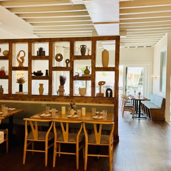 Opal - a dining room with wooden tables and chairs - New American Near Me - Washington, DC, District of Columbia