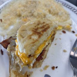Split View of the bacon, egg, and cheese biscuit with grits (added cheese) Split View of the bacon, egg, and cheese biscuit with grits (added cheese)