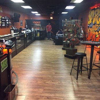Vapes and Vapor - Flavor bar on the left and people in the back relaxing on the sofas! - Vape Shops Near Me - Palos Park, Illinois Vapes and Vapor - Flavor bar on the left and people in the back relaxing on the sofas! - Vape Shops Near Me - Palos Park, Illinois