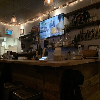 Afrobeat Kitchen - a bar with a large screen tv - African Near Me - Toronto, Ontario