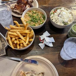 The chicken is served on a separate tray. Sides are French fries, fried rice and corn salad The chicken is served on a separate tray. Sides are French fries, fried rice and corn salad