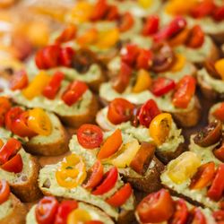 Elisa's Catering - Avocado Cream Cheese Crostini with Marinated Heirloom Tomatoes. I"M BEGGING YOU TO GET THESE! THEY'RE SO GOOD!