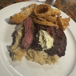 Peppered flank steak, gorgonzola butter, onion rings, mashed potatoes Peppered flank steak, gorgonzola butter, onion rings, mashed potatoes