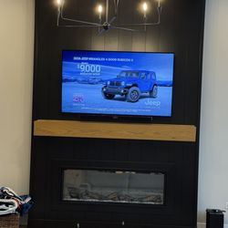 HDforever Electric Solutions - Newly mounted tv and sound bar above fireplace.