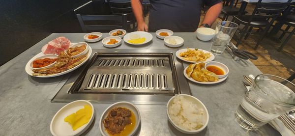 Photo of DAE GEE KOREAN BBQ - Denver, CO, US. a man standing in front of a bbq grill