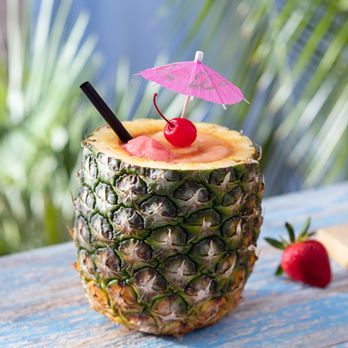 Bahama Breeze - Ultimate Pineapple – With spiced rum, Coco López & Bacardi Black Rum swirled with strawberry ice and served in a freshly cut pineapple - Bars Near Me - Lutz, Florida