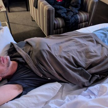 Hotel Murano - My husband using his sweatshirt as a blanket because there is none for the sofa bed and a four person reservation. - Hotels Near Me - Tacoma, Washington