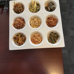 9 banchan (spicy garlic scapes on bottom) 9 banchan (spicy garlic scapes on bottom)