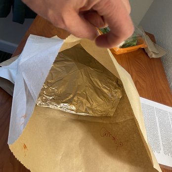 Pickup's Pizza Company - a person picking up a piece of foil from a bag - Pizza Near Me - Eagle, Colorado