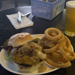 Cheddar cheese burger with sautéed onions and onion rings.