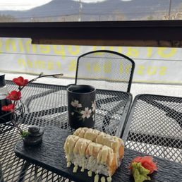 Autumn Colombus Roll with spicy salmon filling, avocado and salmon on top.