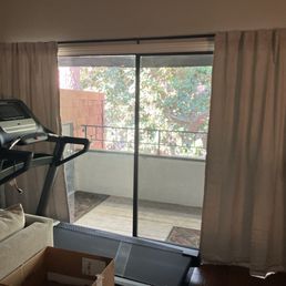Main living room patio window with new curtain rod installed