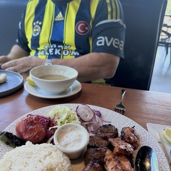 Turkish Kitchen - Joe reaches for seeded bread as our meal arrives. - Mediterranean Near Me - Brandon, Florida