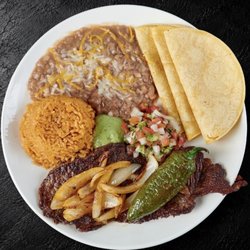 Fuego Cravings - A hearty 7oz steak served with fluffy rice, hearty beans, creamy guacamole sauce, fresh pico de gallo, a spicy chile toreado, grilled onions