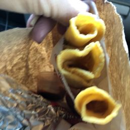 Taquitos, green chile, and tacos on the bottom of the bag.