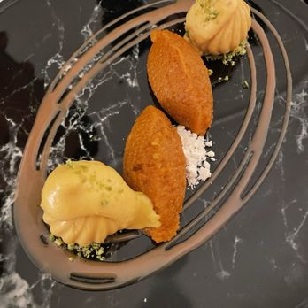 Adrak - a plate of desserts on a marble table - Indian Near Me - Toronto, Ontario