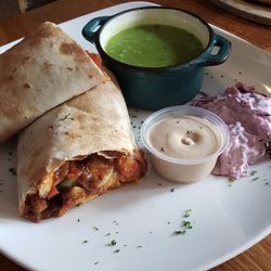 The Singing Pub - Cajun chicken wrap with coleslaw and mushy peas