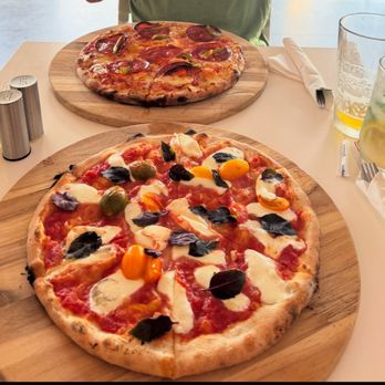 Lluvia Deli Bar - Bee Sting pizza in background. The Margherita in the foreground - Coffee & Tea Near Me - Rio Grande, Puerto Rico Lluvia Deli Bar - Bee Sting pizza in background. The Margherita in the foreground - Coffee & Tea Near Me - Rio Grande, Puerto Rico