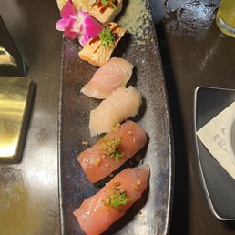 Top to bottom: torched salmon belly nigiri, kona kanpachi nigiri, and poke flavor nigiri Top to bottom: torched salmon belly nigiri, kona kanpachi nigiri, and poke flavor nigiri