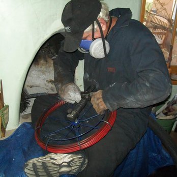 K.C. Wester - K.C. at work cleaning a kiva fireplace - Chimney Sweeps Near Me - Santa Fe, New Mexico