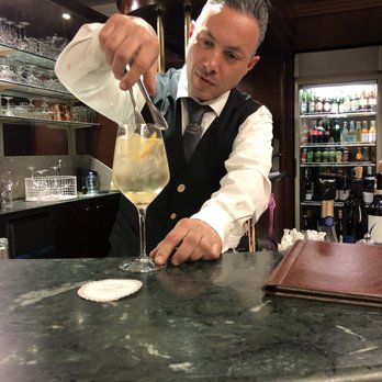 Hotel Eden Roc - Giuseppe mastering a St Germaine Spritzer with fresh lemon, orange and mint from the hotel garden. - Hotels Near Me - Positano, SA Hotel Eden Roc - Giuseppe mastering a St Germaine Spritzer with fresh lemon, orange and mint from the hotel garden. - Hotels Near Me - Positano, SA