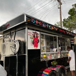 a food truck with a woman in a red dress