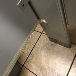 Women's bathroom stall wall being held together with tape...