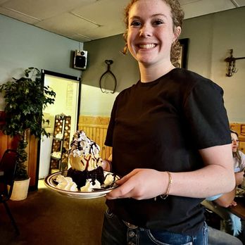 Frontier Bar & Supper Club - Ellie, delivering our Lava Cake with a smile! - Steakhouses Near Me - Shelby, Montana
