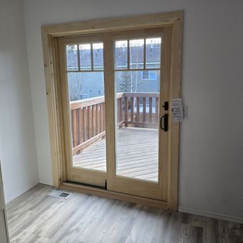 Renewal by Andersen - Pine trim French patio doors and black hardware. - Windows Installation Near Me - Tempe, Arizona Renewal by Andersen - Pine trim French patio doors and black hardware. - Windows Installation Near Me - Tempe, Arizona
