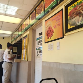 USA Deli - a man ordering food at a counter - Chicken Wings Near Me - Atlanta, Georgia USA Deli - a man ordering food at a counter - Chicken Wings Near Me - Atlanta, Georgia